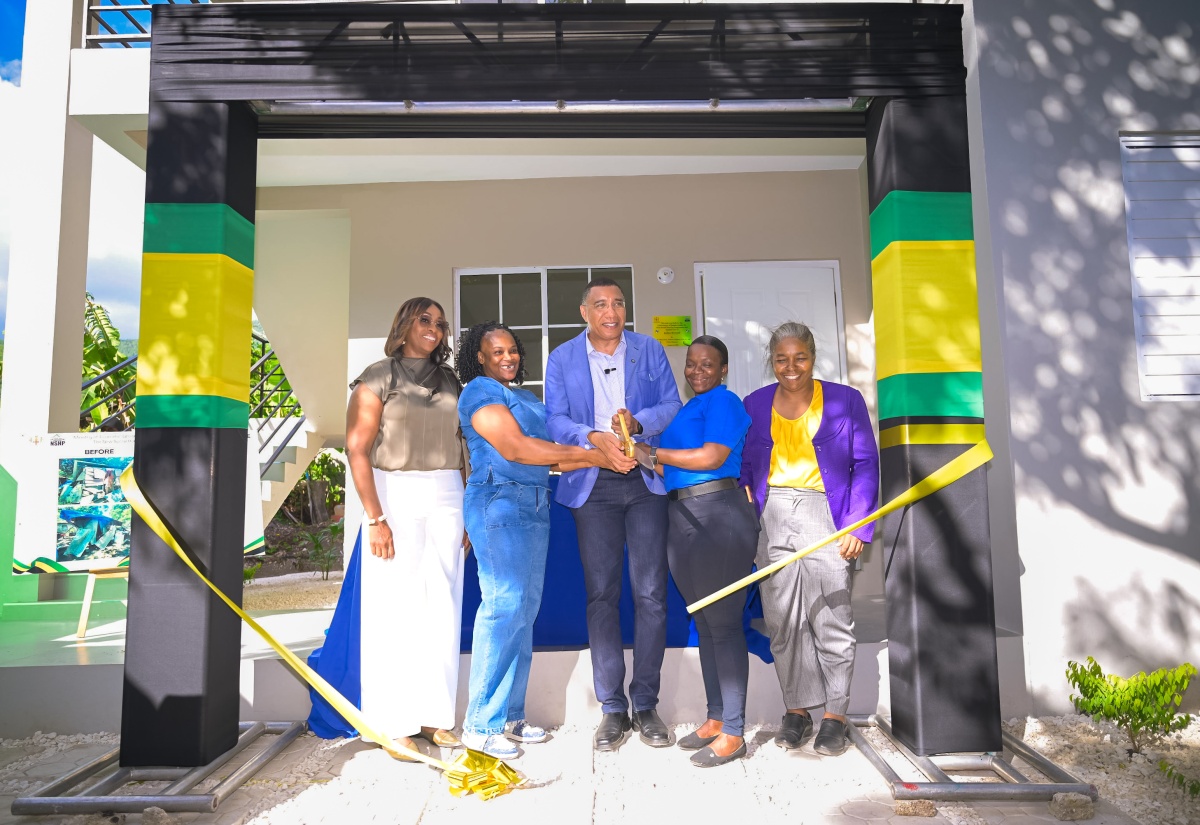 Prime Minister, Dr. the Most Hon. Andrew Holness (centre), assists sisters Ysanne McNicle (second left) and Jodian Bernard (second right) in cutting the ribbon to their new home in Greendale district in Bull Bay, St. Andrew, on Wednesday (October 21). The multi-family housing unit was built under the New Social Housing Programme (NSHP). They are joined by Speaker of the House of Representatives and Member of Parliament for St. Andrew East Rural, the Most Hon. Juliet Holness (left), and Chairperson, NSHP Oversight Committee, Judith Robb Walters.

