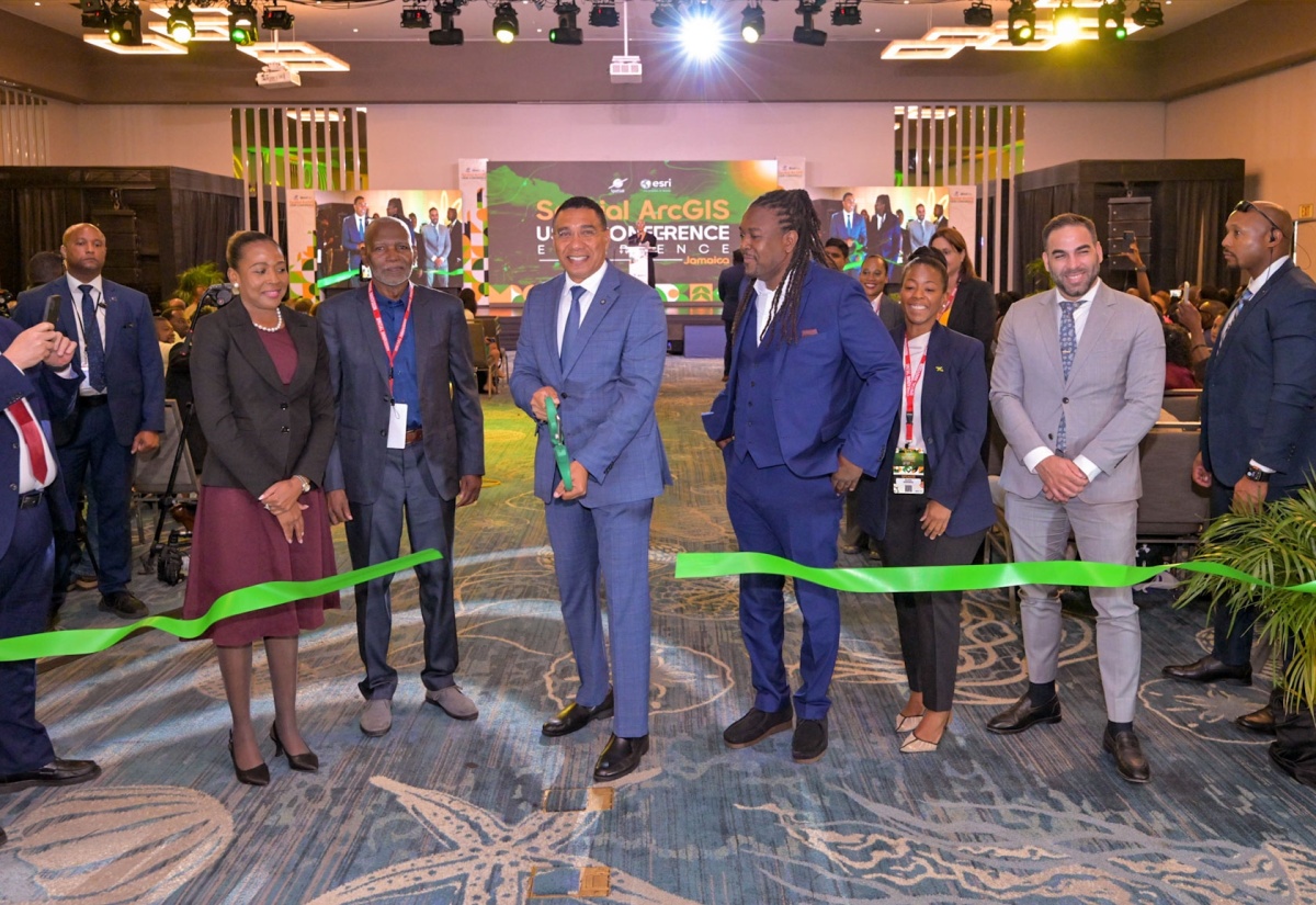 Prime Minister, Dr. the Most Hon. Andrew Holness (center), cuts the ribbon to open the exhibition hall at the Spatial ArcGIS User Conference held recently at the AC Marriott Hotel in Kingston.  Looking on (from second left) are Caribbean Lead in Fugro's Climate and Nature Practice, Dr. Valrie Grant; Chief Executive Officer (CEO)/Chairman, Spatial Innovision, Dr. Silburn Clarke; Deputy CEO of Spatial Innovision, Roshaun Clarke; Principal Director, National Spatial Data Management Branch at the Ministry of Economic Growth and Infrastructure Development (MEGID), Alicia Edwards, and Technical Advisor, Office of the Prime Minister, Alexander Causwell.

