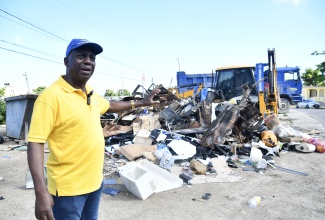Executive Director of the National Solid Waste Management Authority (NSWMA), Audley Gordon, points to a mound of bulky waste during a clean-up activity by the agency at the garbage holding area in Norwood, St. James, recently.

