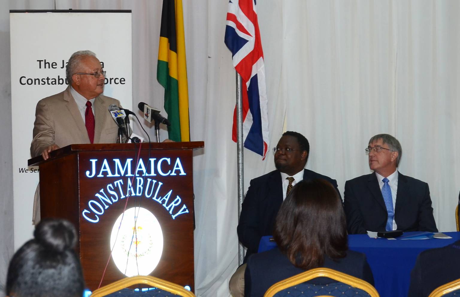 Justice Minister, Hon. Delroy Chuck (at podium), addresses the launch of the Jamaica Constabulary Force’s (JCF) computerized criminal records system, at the Police Officers’ Club on Hope Road in St. Andrew, on June 3. Sated at the head table (from left) are: Communications Consultant with the Ministry of National Security, Mark Thomas, who chaired the function; and Project Executive with the United Kingdom-based ACRO Criminal Records Office, David McKinney.