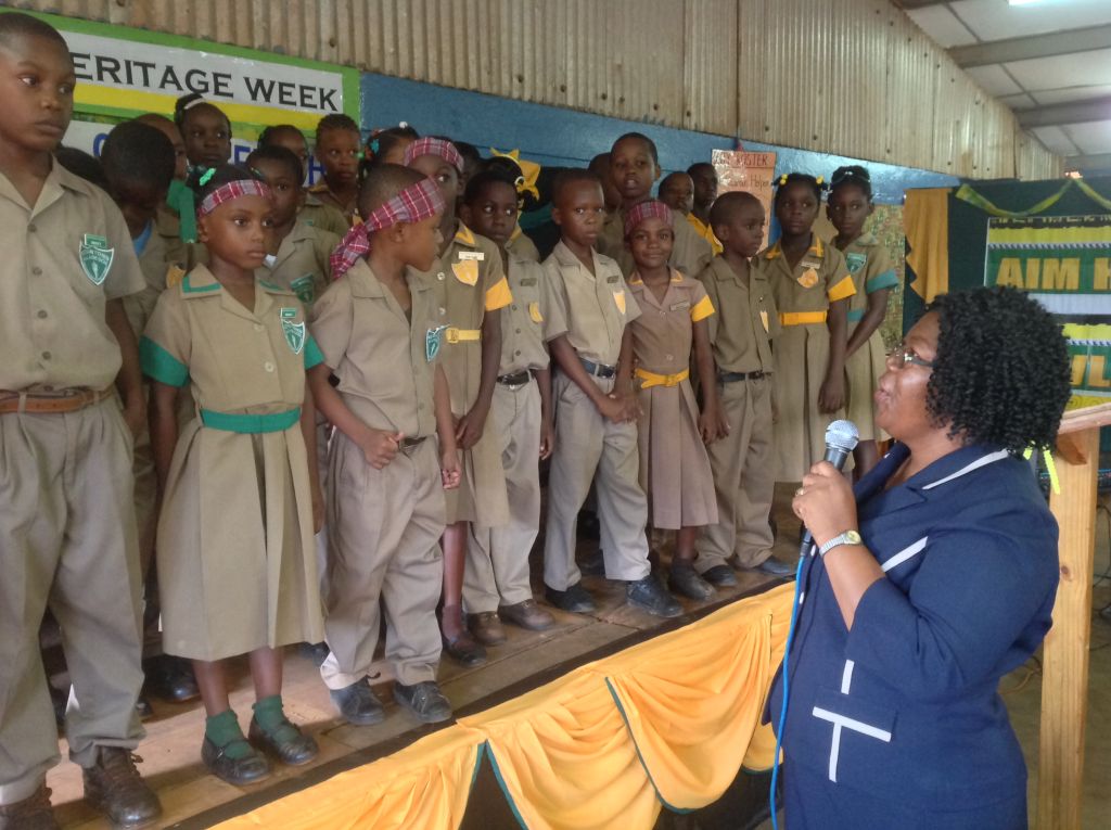 Principal of the Kitson Town All Age School in St. Catherine, Nerica Powell-Hay (right), addresses a group of newly installed students leaders, during a ceremony held at the institution yesterday (Oct. 16), which was also used to recognize the contributions of the country’s National Heroes.