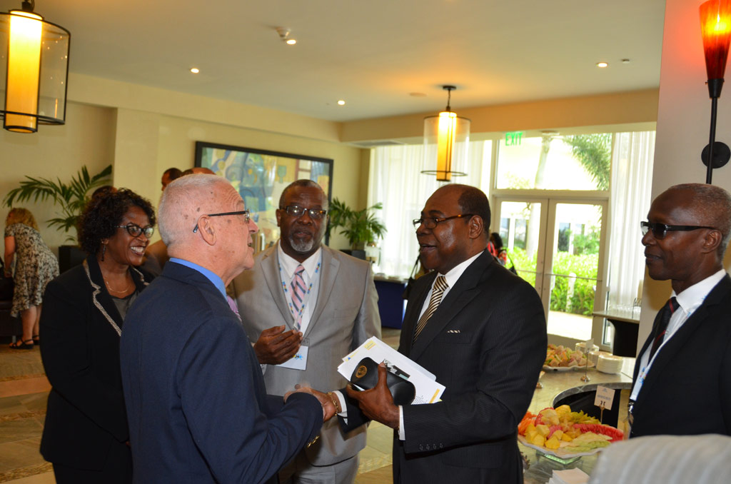 Minister of Education, Rev. the Hon. Ronald Thwaites (2nd left), exchanges pleasantries with Member of Parliament for East Central St. James, Edmund Bartlett (2nd right), at yesterday’s (July 11) opening ceremony of the 12th Annual Conference of the Association of Caribbean Higher Education Administrators (ACHEA), at the Hilton Rose Hall Resort and Spa in Montego Bay, St. James yesterday (July 11). Looking on are President of ACHEA, Dr. Kofi
Nkrumah-Young (centre) and Immediate Past President of ACHEA, Clement Iton (right).