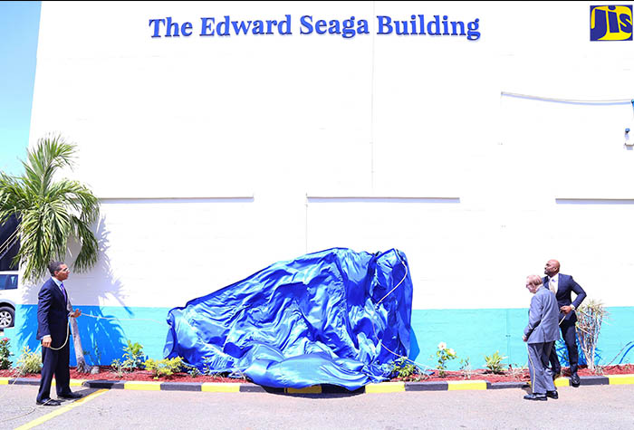 Prime Minister, the Most Hon. Andrew Holness (left); former Prime Minister, the Most Hon. Edward Seaga (centre); and Minister of Science, Energy and Technology, Dr. the Hon. Andrew Wheatley, unveil ‘The Edward Seaga Building’ sign at the corporate office of Petrojam Limited located on Marcus Garvey Drive in Kingston on Thursday (February 22). The  building was named in honour of Mr. Seaga’s contribution to the establishment and development of Petrojam’s operations.