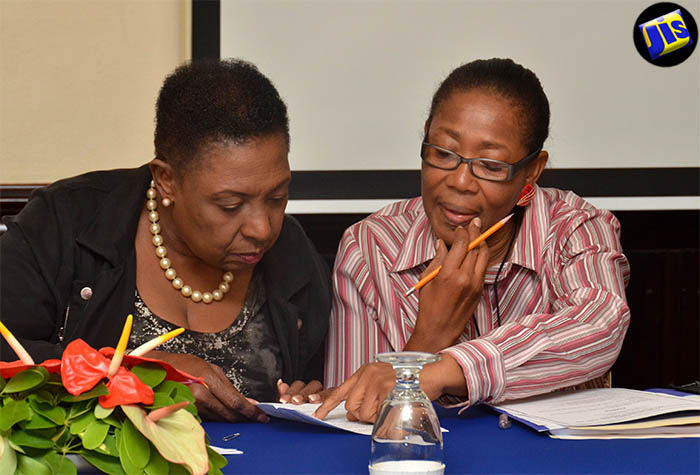 Minister of Culture, Gender, Entertainment and Sport Hon Olivia Grange (left), in discussion with Senior Director in the Ministry's Sport Division, Florette Blackwood, during the recent orientation session for newly appointed members of the independent Jamaica Anti-Doping Disciplinary Panel and Jamaica Anti-Doping Appeals Tribunal, at The Courtleigh Hotel & Suites in New Kingston.