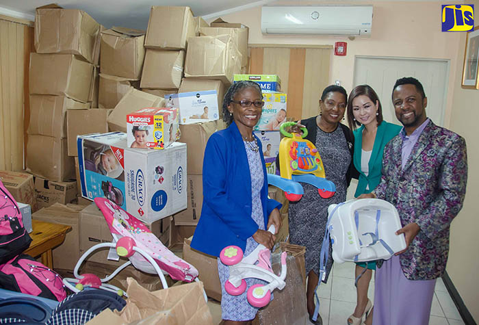 Minister of Culture, Gender, Entertainment and Sport, Hon. Olivia Grange (2nd right), and Executive Director of the Women’s Centre of Jamaica Foundation (WCJF), Dr. Zoey Simpson, accept baby supplies from Bishop Dr. Durone Hepburn (2nd left) and his wife, Phuong Hepburn, from the Joyously Unveiling the Master’s Plan (J.U.M.P.) Ministries Global Church. The items, which will benefit adolescent mothers from the WCFJ’s 18 sites across the island, were handed over on May 9, at the WCJF’s Trafalgar Road headquarters in St. Andrew.