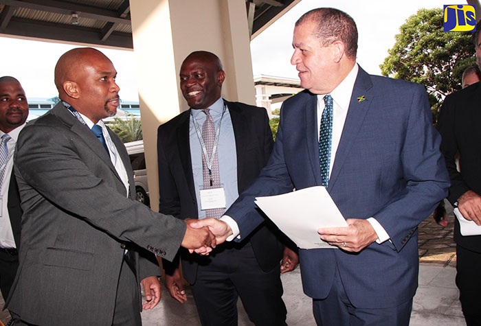
Minister of Finance and the Public Service, Hon. Audley Shaw (second right), is greeted by Vice President for Investment Banking at the National Commercial Bank (NCB) Herbert Hall (second left), when he arrived to address the  LatinFinance’s 2nd Caribbean Finance and Investment Forum, held on November 17 at the Montego Bay Convention Centre. Others (from left) are Chief Executive Officer at NCB Capital Markets, Steven Gooden; Resident Representative of the International Monetary Fund (IMF), Constant Lonkeng, and CEO of LatinFinance, Taimur Ahmad. 
