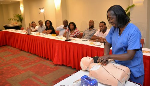 Life Support Instructor in the United States (US), Delores McGregor, demonstrates the cardiopulmonary resuscitation (CPR) procedure to athletic coaches and nurses from five educational institutions, which benefitted from donations of automated external defibrillators (AED) from Team Jamaica Bickle. The presentation of equipment and training session took place yesterday (June 18) at the Hilton Hotel in Montego Bay. The occasion was part of the Diaspora Day of Service, an event of the 6th biennial Jamaica Diaspora Conference held from June 13-18 at the Montego Bay Convention Centre.