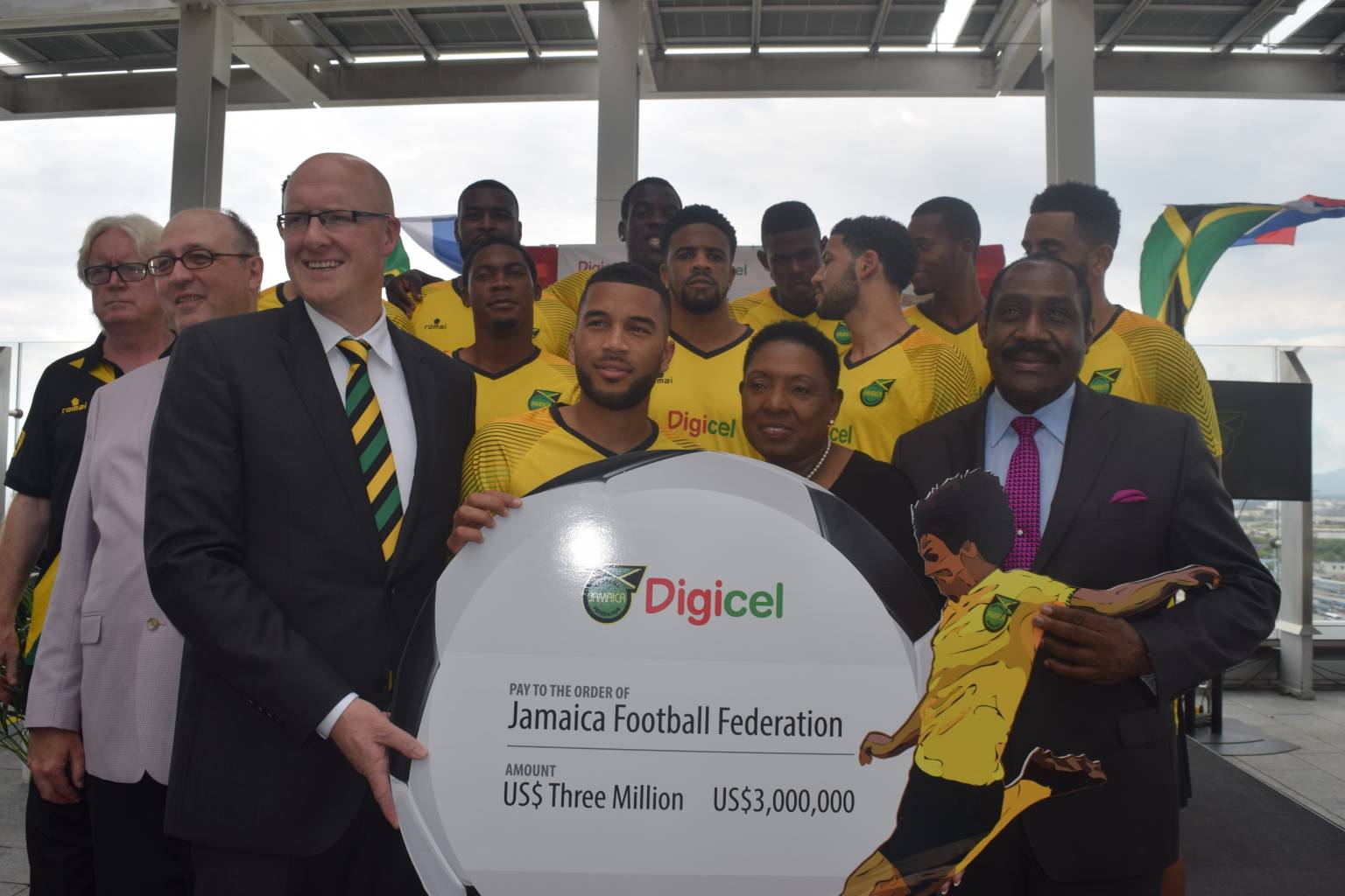 (Second right) Minister of Culture, Gender, Entertainment and Sport (CGES), Honourable Olivia ‘Babsy’ Grange  shared a photo opportunity with members of the National Football Team as they received a cheque from (left)  CEO, Digicel, David Butler to aid their quest to World Cup 2018. The moment was also shared with (right) President, Jamaica Football Federation, Captain Horace Burrell.