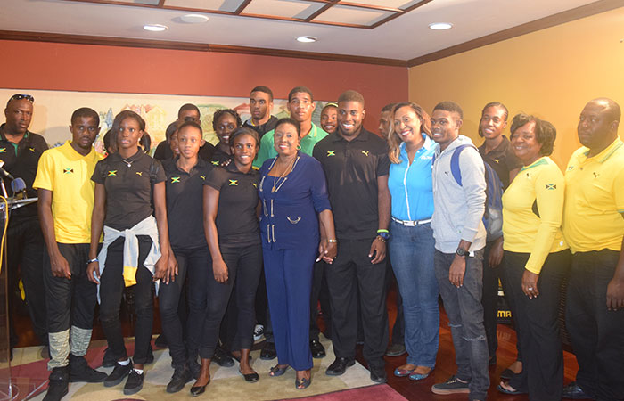 Minister of Culture, Gender, Entertainment and Sport, the Honourable Olivia ‘Babsy’ Grange with members of the track and field team that represented Jamaica at the recently concluded 45th CARIFTA Championships held in Grenada, following their arrival at the Norman Manley International Airport in Kingston on Tuesday, March 29, 2016. 