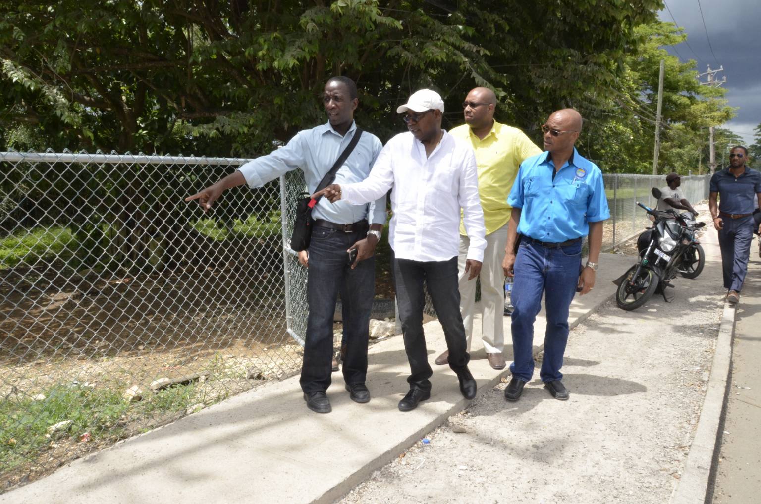 Tourism Minister, Hon. Edmund Bartlett (2nd left) examines a sidewalk project being undertaken in Negril with support from the Tourism Enhancement Fund (TEF). Occasion was a tour of the resort town on May 28. Others (from left) are: Director of Projects at TEF, Christopher Miller; Senior Communications Advisor to the Minister, Delano Seiveright; and Executive Director of the Tourism Product Development Company (TPDCo), Dennis Hickey.