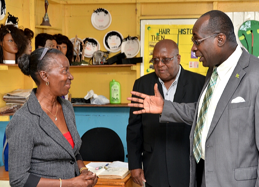 Minister of Education, Youth and Information, Senator the Hon. Ruel Reid (right), in discussion with Principal of the Best Care Special Education School, Autense France (left), during a tour of the institution in Kingston, on May 4. At centre is  Chairman of the Best Care Foundation.