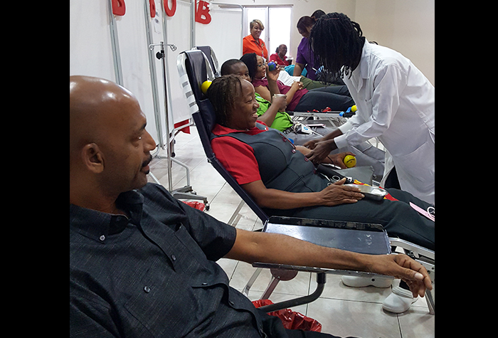 Persons donate blood inside the ballroom of the Golf View Hotel in Mandeville, Manchester, on World Blood Donor Day, June 14.