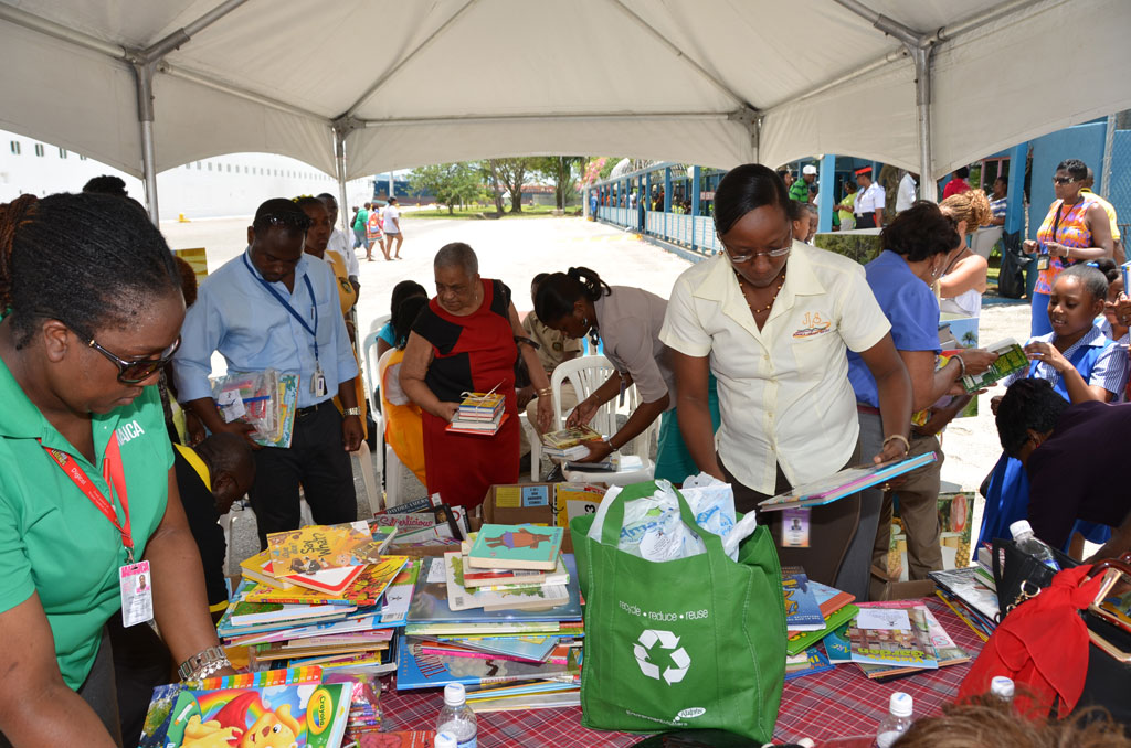 Representatives of the St. James Parish Library,  Jamaica Tourist Board (JTB), and Blue World Travels, engage in sorting out the over 1000 books that were presented by passengers of the Cruise Ship, Festival at Sea, for students across western Jamaica, after the vessel docked in Montego Bay, St. James, last week. The donations, which were facilitated through United States-based Blue World Travels, were handed over to representatives of the Ministry of Education and JTB, during a brief presentation ceremony at the Montego Bay Cruise Ship Terminal.