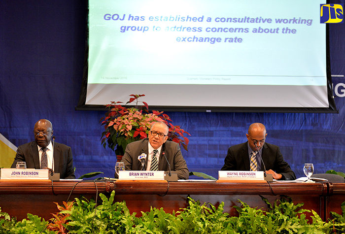 Bank of Jamaica (BoJ) Governor, Brian Wynter (centre), responds to a question during the Bank’s quarterly media briefing at the BOJ auditorium in downtown Kingston on Monday (November 14). Others (from left are BOJ Senior Deputy Governor, John Robinson; and Deputy Governor, Dr. Wayne Robinson.