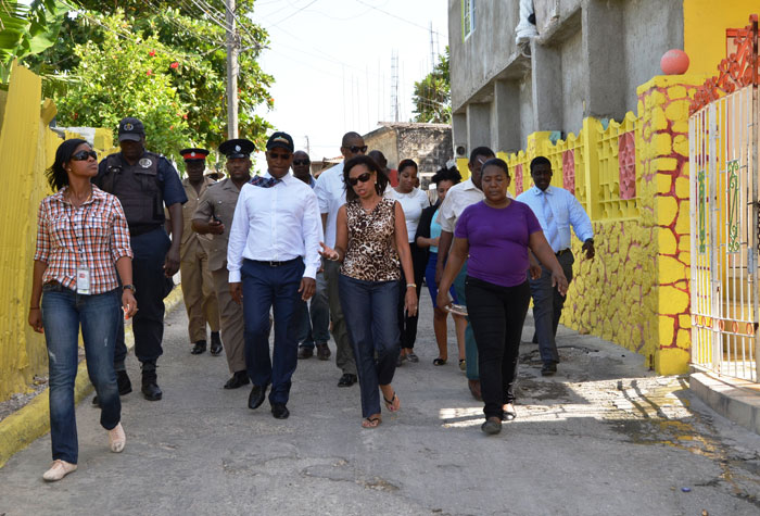 State Minister for Investment, Industry and Commerce and West Central St, James Member of Parliament, Hon. Sharon Ffolkes Abrahams (3rd right), converses with National Security Minister, Hon. Peter Bunting (4th left), during a recent tour of Mount Salem, St. James. 