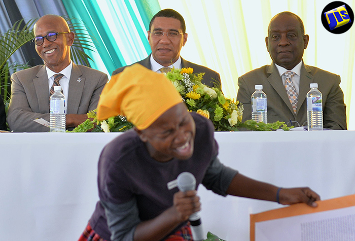 Prime Minister, the Most Hon. Andrew Holness (centre); Minister without Portfolio in the Office of the Prime Minister, Hon. Derrick Smith (right) and Managing Director of the Development Bank of Jamaica (DBJ), Mr. Milverton Reynolds, enjoy the performance of Asley Grey, at a ceremony at Jamaica House on August 23, where some 220 land titles were handed over to recipients from across the island.