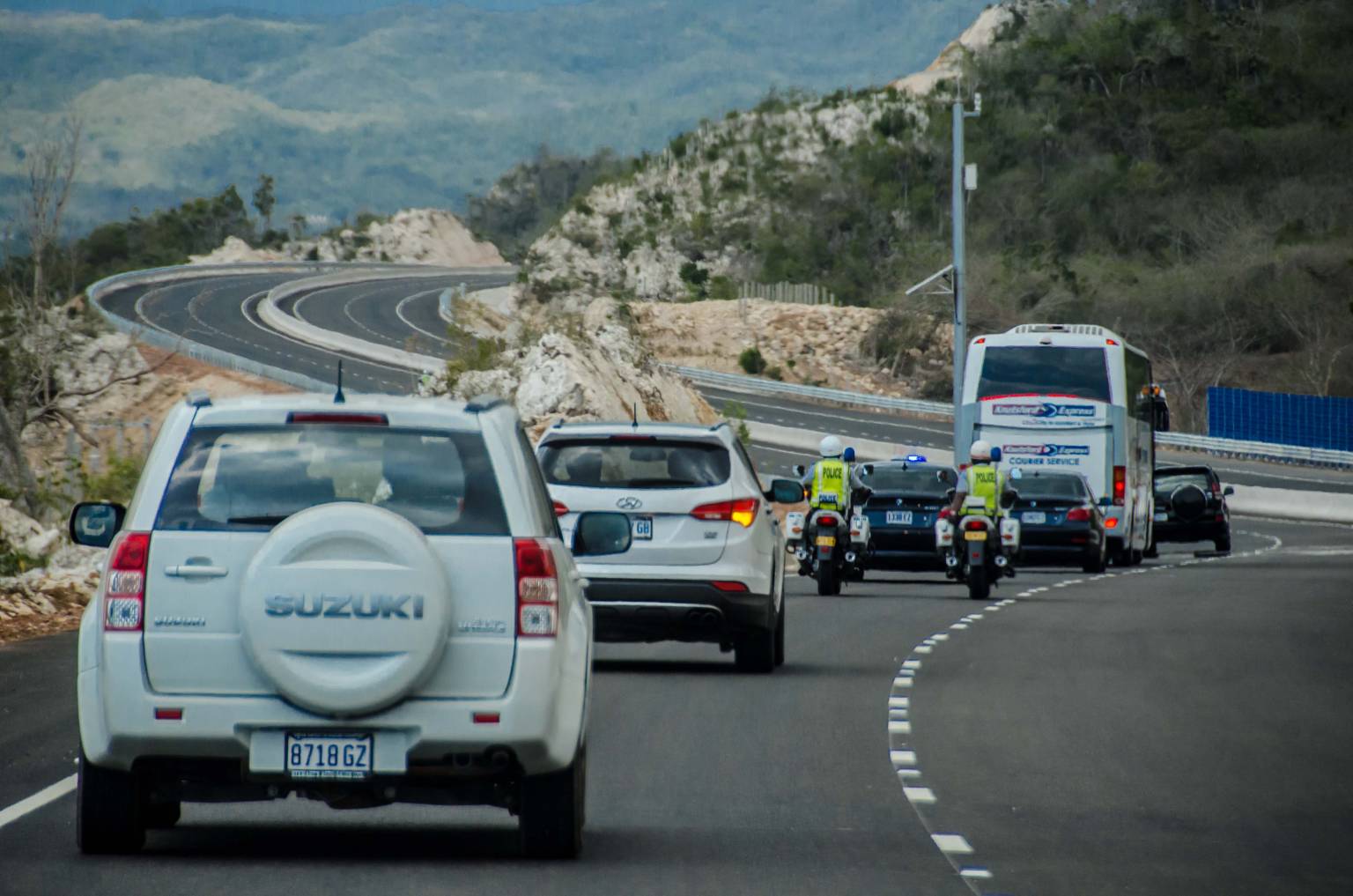 Government officials and representatives of China Harbour Engineering Company Ltd. traverse a section of North South leg of Highway 2000, following Wednesday’s ( March 23) official opening.