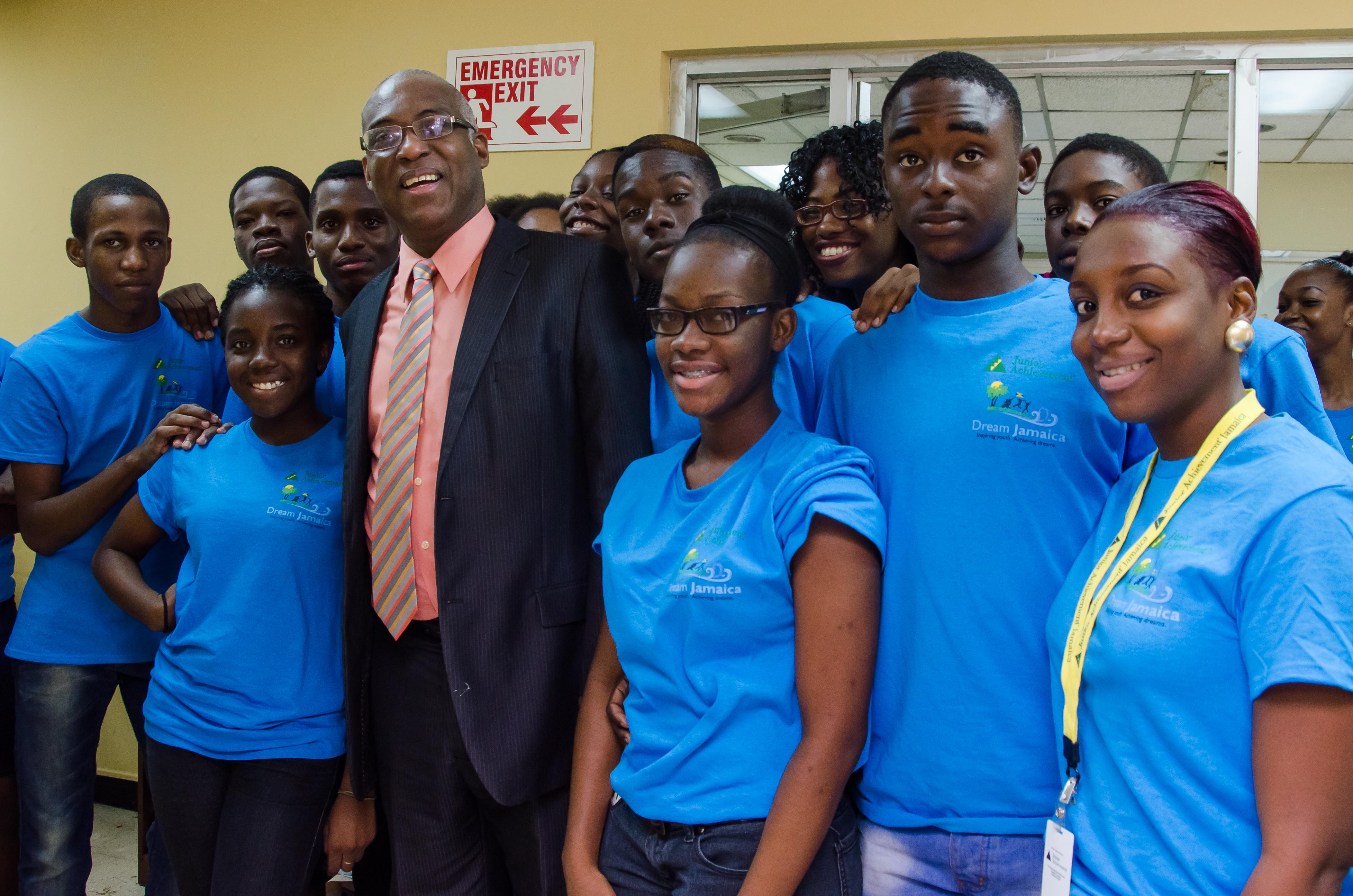 Members of Junior Achievement Jamaica Summer programme with Deputy Chief Executive Officer of the Jamaica Information Service (JIS), Mr. Ian Boyne, when they toured the agency on  July 23. At right is Junior Achievement Jamaica’s BizTown Supervisor, Yaneik Thomas.