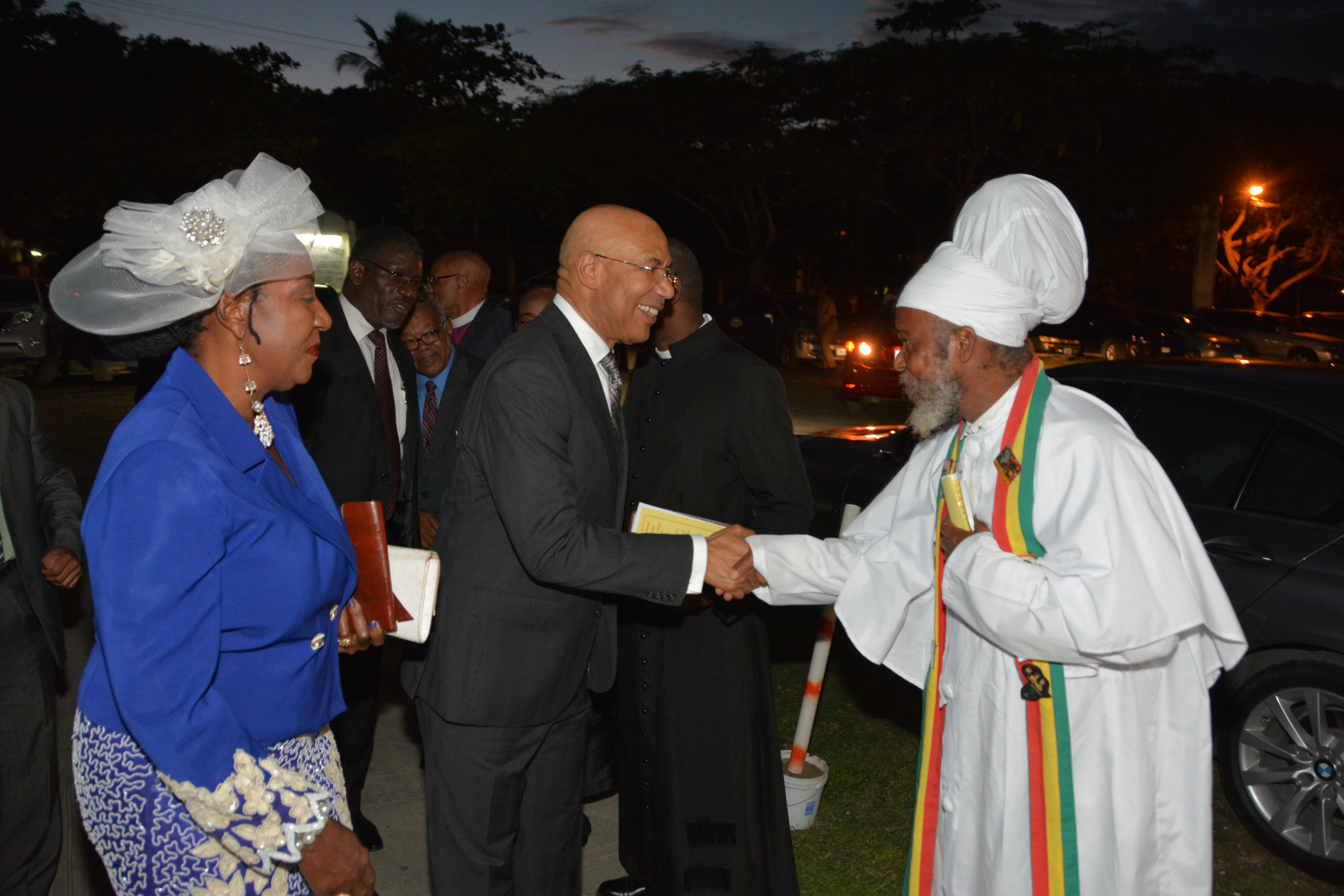 Governor General, His Excellency the Most Hon. Sir Patrick Allen (2nd right), is greeted by Priest Rudolph Bailey of the Rastafari community, as he arrived at the Ocho Rios Baptist Church in St. Ann on December 13, for the 23rd Annual National Prayer Vigil under the theme: ‘Justice, Unity, Peace and Healing’.