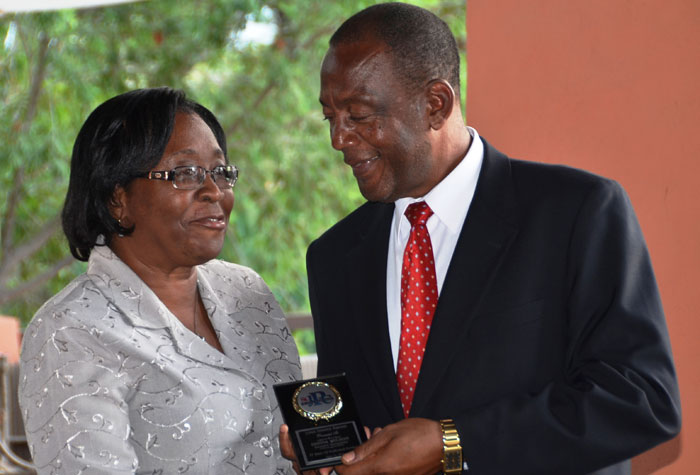 Mayor of Montego Bay, Councillor Glendon Harris (right), presents an award to Donna Wilson of the St. James Parish Council’s Administration Department, in recognition of her 35 years of service to the Municipality. The presentation took place on  June 25, at the inaugural St. James Parish Council staff awards ceremony, held at the Seawind Beach Club in Montego Bay.