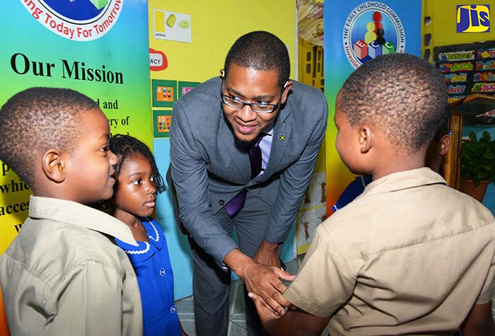 In this file photo, State Minister in the Education, Youth and Information Ministry, Hon. Floyd Green (third left), interacts with (from left): Dammi Hannigan, Dominique Parkes and Drew Stewart of the St. Margaret’s Basic School in Portland on January 26. Occasion was a ceremony organised by the Early Childhood Commission (ECC) to announce the certification of the school.
	
