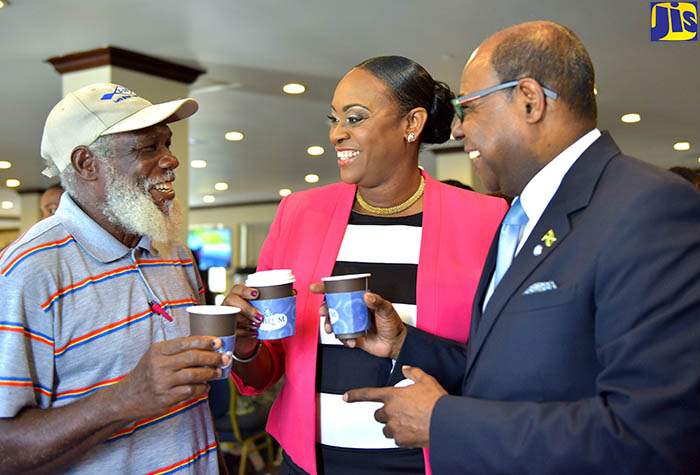 Tourism Minister, Hon. Edmund Bartlett (right), enjoys a cup of coffee with wife of the Prime Minister, the Most Hon. Juliet Holness (centre); and Vice President of the Cottage Farmers Group of East Rural St. Andrew, Mervin Hibbert (left), at the press launch of the Jamaica Blue Mountain Coffee Festival, at The Jamaica Pegasus hotel in New Kingston on January 23. 