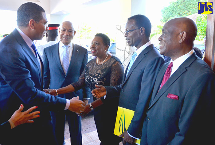 Prime Minister, the Most Hon. Andrew Holness (left)  greets Minister of Culture, Gender, Entertainment and Sport, Hon. Olivia Grange (third left) on his arrival at the Andrew's Memorial Seventh-day Adventist Church, 29 Hope Road. The occasion was the National Heritage Week Thanksgiving Church Service held today (October 8) at the church. Observing from second left are Governor General His Excellency the Most Hon. Sir Patrick Allen, Chairman of the Committee for the Promotion of National Religious Services, Pastor Adrian Cotterell and Pastor of the Andrew's Memorial Seventh-day Adventist Church, Leonard Steele.