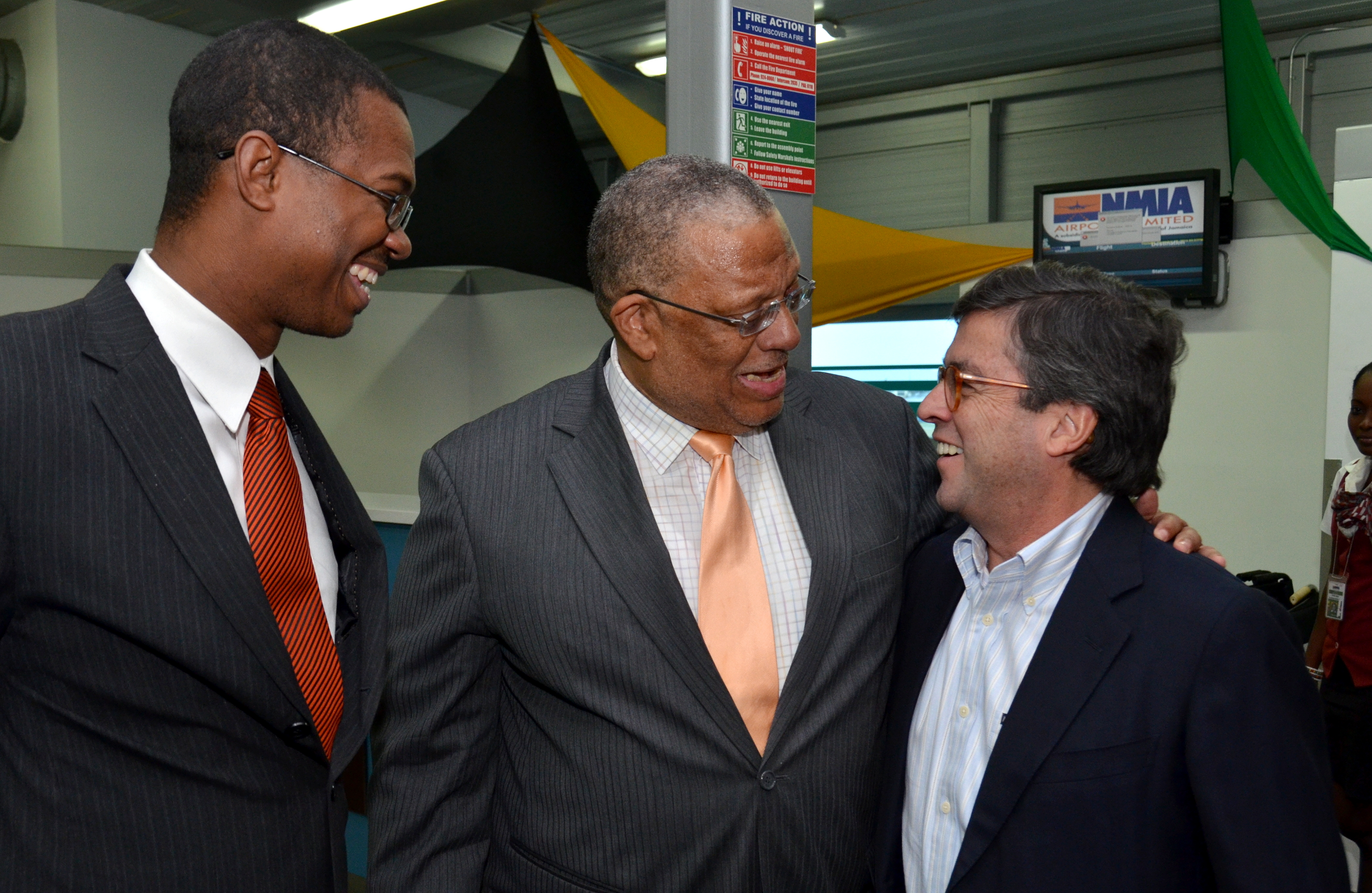Minister of Finance and Planning, Dr. the Hon. Peter Phillips (centre), warmly welcomes Inter-American Development Bank (IDB) President, Luis Alberto Moreno (right), on his arrival at the Norman Manley International Airport this afternoon (December 17), for a two-day visit. Also on hand to welcome the IDB President is Minister of State in the Ministry of Foreign Affairs and Foreign Trade, Hon. Arnoldo Brown. President Moreno’s visit coincides with activities surrounding the celebration of the IDB’s 45 years of partnership with Jamaica and will include tours of IDB-funded projects, a ground-breaking ceremony at the construction site of the new IDB offices in Kingston, and a cultural reception for IDB partners, stakeholders and staff.