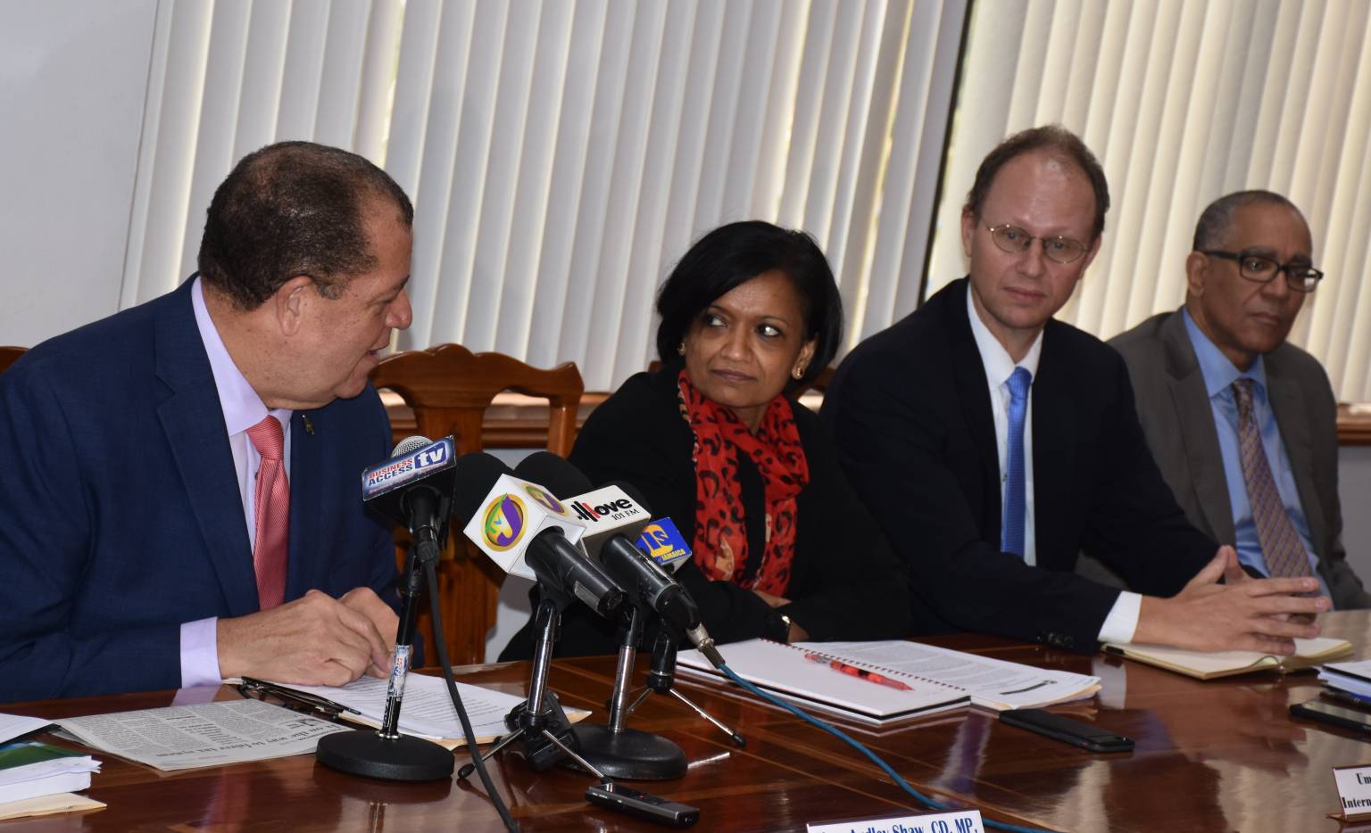 Finance and Public Service Minister, Hon. Audley Shaw (left), makes a point to International  Monetary Fund (IMF) Staff Mission Team Head to Jamaica, Dr. Uma Ramakrishnan (2nd left), during Friday’s (May 20) IMF quarterly review media briefing at the Ministry’s offices in Kingston. Others (from third left) are:  IMF Representative to Jamaica, Dr. Bert Van Selm; and Bank of Jamaica (BoJ) Governor, Brian Wynter.