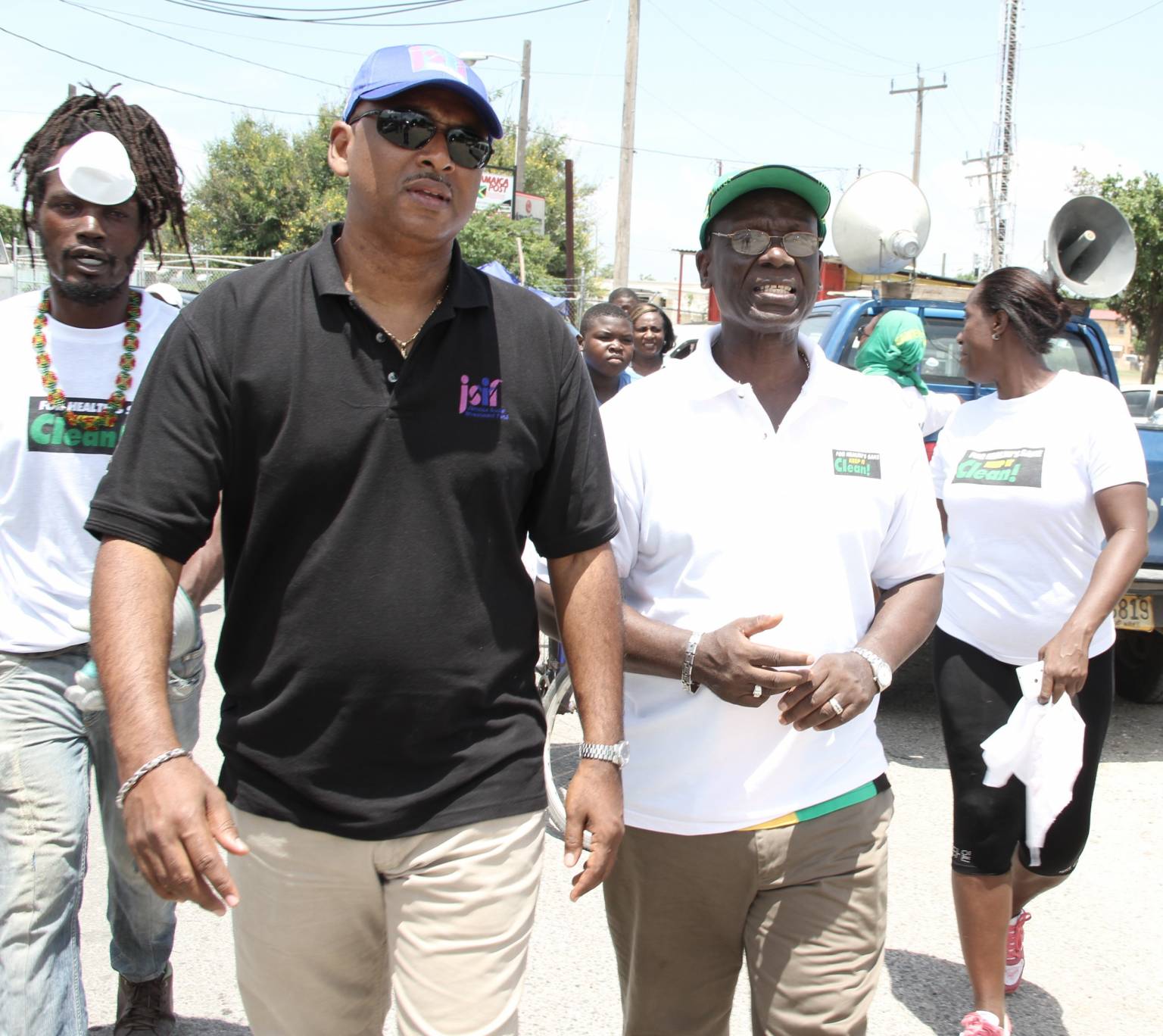 Minister of Local Government and Community Development, Hon. Desmond McKenzie (right) and Managing Director of the Jamaica Social Investment Fund (JSIF), Omar Sweeney (left),  join  volunteers for the National Labour Day Project in Gregory Park, Portmore on Labour Day (May 23). 