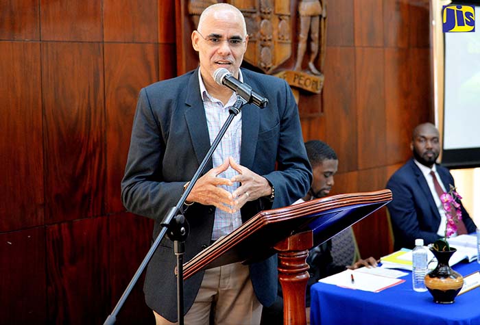 Co-Chair of the Economic Programme Oversight Committee, Keith Duncan, addresses attendees at the inaugural Think Tank of the Jamaica House Fellowship Programme at Jamaica House on Tuesday (September 19). Mr. Duncan was guest speaker at the event. Also pictured at the head table (from left) are Jamaica House Fellow, Lavois Cruickshank; and Team Lead, Mark Tracey.
