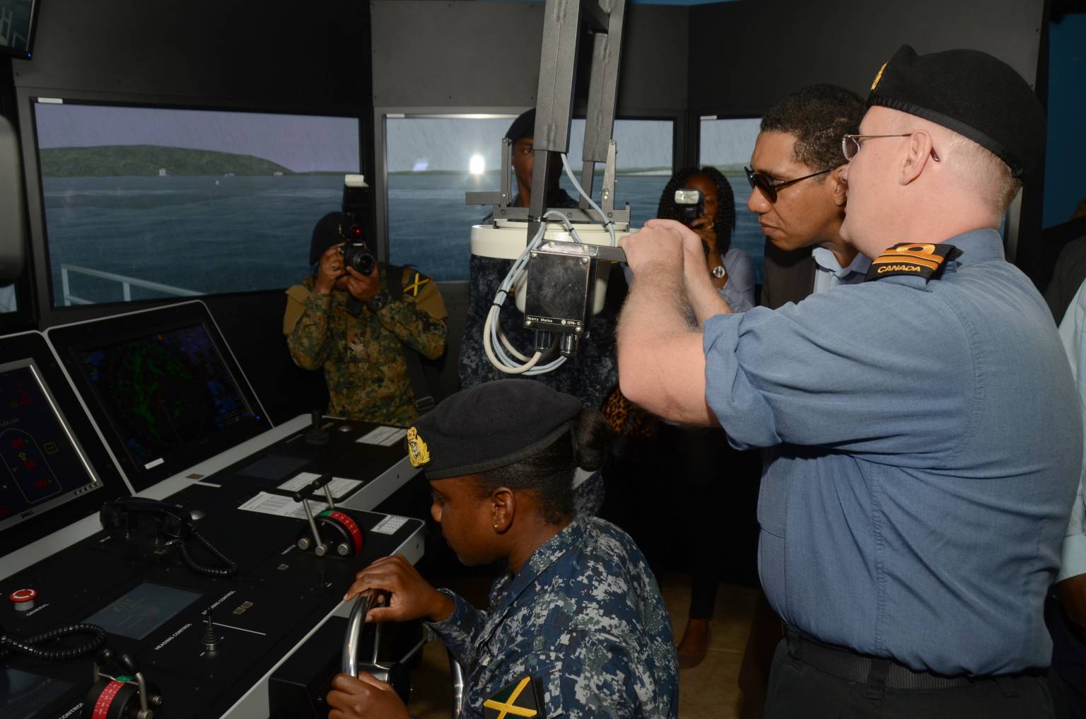 Prime Minister, the Most Hon. Andrew Holness (right), tries out a simulator used in the training of sailors across the region, while Canadian instructor, Lt. Navy Gregory Kuhn, provides instruction. Occasion was a tour of the Jamaica Defence Force (JDF) Coast Guard in Port Royal on Thursday (May 26). Mr. Holness also toured sections of Up Park Camp, as well as the Twickenham Park Range in Spanish Town, St. Catherine.