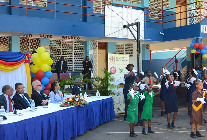 Students at the new Red Hills Primary School, in St. Andrew, perform during the recent official opening. Enjoying the  performance at third left  is  the Minister of Education, Hon. the Rev. Ronald Thwaites.   Others (from left) are:  Member of Parliament for the area, Mr. Paul Buchanan and Opposition Leader, Mr. Andrew Holness. The new school, which replaces the Red Hills All Age, will accommodate 630 students. 