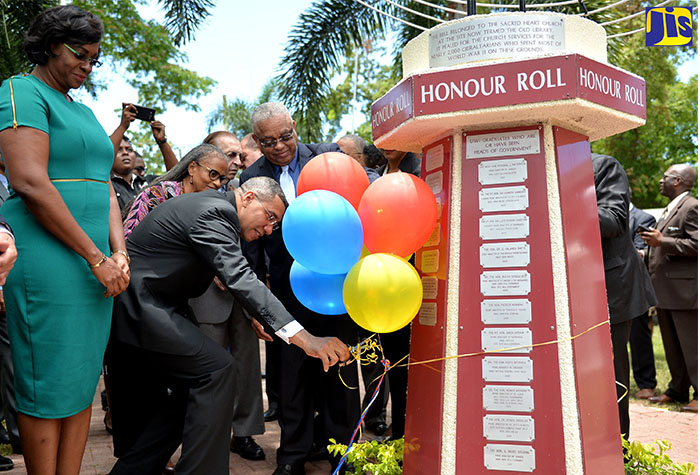 Prime Minister, the Most Hon. Andrew Holness (second left), cuts the ribbon to unveil his name, which has been inscribed on the monument erected at the Park of Honour at the University of the West Indies, Mona. Occasion was the induction of the Prime Minister in the Park of Honour on Wednesday (May 3). Observing (from left) are the Prime Minister’s wife, the Most Hon. Juliet Holness; Campus Registrar, Dr. Camille Bell-Hutchinson; former Prime Minister, the Most Hon. Edward Seaga; and Pro-Vice Chancellor and Principal, UWI, Mona, Prof. Archibald McDonald.