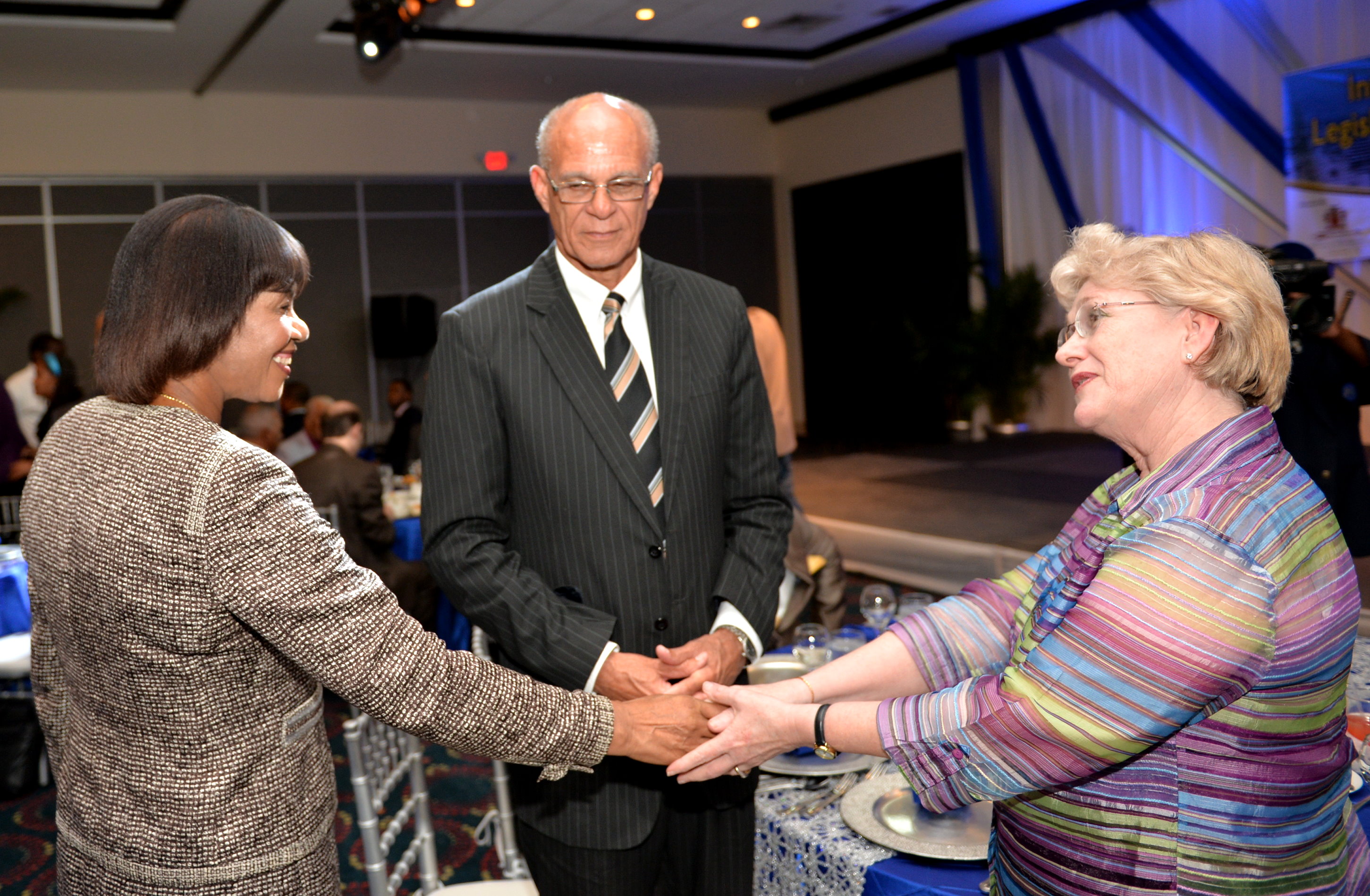 Prime Minister, the Most Hon. Portia Simpson Miller (left) is greeted by Chief Financial Management Officer, World Bank, Jennifer Thomson (right), when she arrived at the Jamaica Pegasus Hotel in New Kingston on Tuesday (June 2) to participate in the opening ceremony for the International Conference on Strengthening Legislative Oversight for Fostering Accountability and Sustainable Growth. Looking on is Speaker of the House of Representatives, Michael Peart.