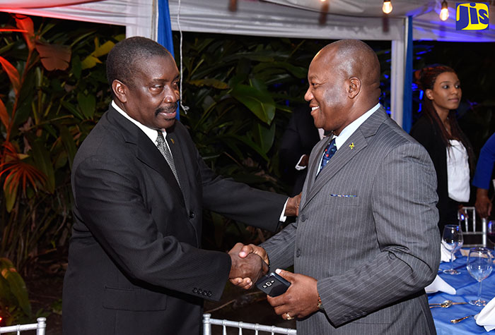 National Security Minister, Hon. Robert Montague (left), greets Commanding Officer for the Jamaica Constabulary Force (JCF) Traffic and Highway Patrol Division, Senior Superintendent Calvin Allen, during the Ministry’s awards ceremony to mark the JCF’s 150th anniversary on Thursday, November 23 at Hope Gardens in St. Andrew.