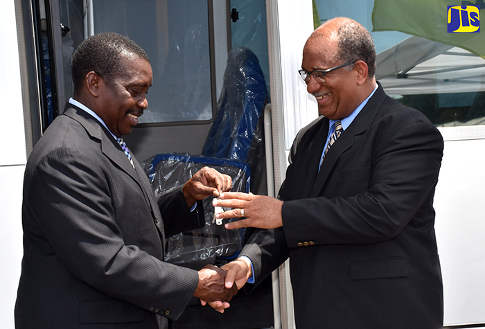 National Security Minister, Hon. Robert Montague (left), presents the keys to a new Mitsubishi Rosa bus valued at $9.8 million, which the Ministry has provided for the Passport, Immigration and Citizenship Agency (PICA), to the entity’s Chief Executive Officer, Andrew Wynter. The presentation was made at PICA’s head office on Constant Spring Road, Kingston, on Tuesday (March 20).