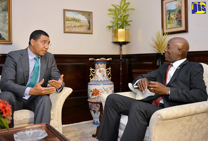 Prime Minister, the Most Hon. Andrew Holness (left), in dialogue with Prime Minister of the Republic of Trinidad and Tobago, Dr. the Hon. Keith Rowley, during a reception hosted in Dr. Rowley’s honour at Vale Royal on July 20.  (File)