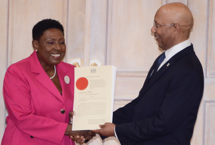 Governor-General Sir Patrick Allen presents the instrument of office to Minister of Culture, Entertainment, Gender Affairs and Sport, the Hon. Olivia Grange on Monday, March 7 at the Swearing In of Cabinet Ministers at King
