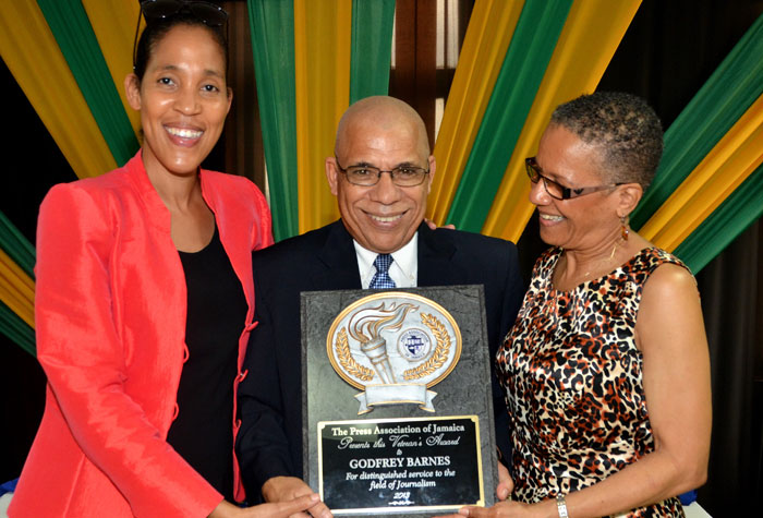 Chief Executive Officer, Jamaica Information Service (JIS), Donna Marie Rowe (left), and Chairman of the JIS’Advisory Board, Fae Ellington (right), congratulate Managing Editor, JIS, Godfrey Barnes, who was presented with a plaque for distinguished service to the field of Journalism. Occasion was the Press Association of Jamaica’s (PAJ) annual Veteran’s Luncheon held on Wednesday (November 27), at J. Wray and Nephew’s Spanish Town Road location.