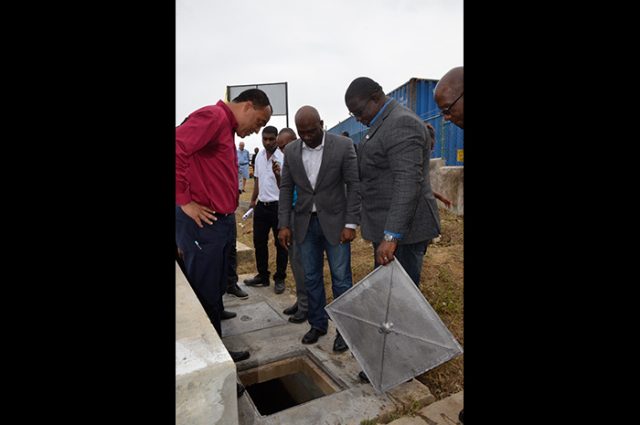 (From left) Minister of Health, Dr. the Hon. Christopher Tufton; Minister of Science, Energy and Technology, Dr. the Hon. Andrew Wheatley; and Executive Director of the Scientific Research Council (SRC), Dr. Cliff Riley, view a section of the bio digester wastewater treatment system at the Noel Holmes Hospital in Lucea, Hanover. The system, built by the SRC, was officially handed over on Thursday (October 26).