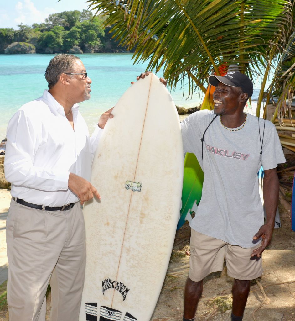 Minister of Tourism and Entertainment, Hon. Dr. Wykeham McNeill (left), interacts with Milton Brown, who rents surf boards on the Boston Beach in Portland. The newly upgraded Boston Beach  was officially handed over to the Portland Parish Council during a ceremony held at the facility on Thursday, January 14. Upgrading work was undertaken through funding provided by the Tourism Enhancement Fund, an agency of the Ministry of Tourism and Entertainment.