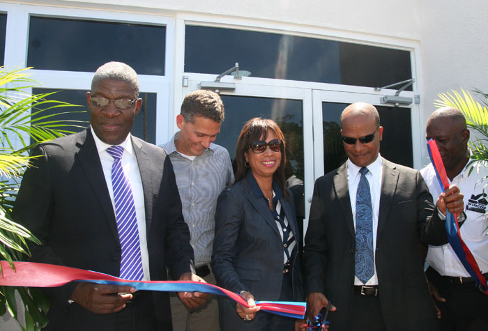 Minister of National Security, Hon. Peter Bunting (fourth left), cuts the ribbon to mark the official handing over of the $12 million Meadows of Irwin Police Post to the Jamaica Constabulary Force (JCF), on February 26.  Sharing in the moment are (from left):  Commissioner of Police, Owen Ellington; Chairman of West Indies Home Contractors (WIHCON), Peter Melhado; Member of Parliament  for West Central St. James, Hon. Sharon Ffolkes-Abrahams; and Managing Director, WIHCON, Delroy Alcott.