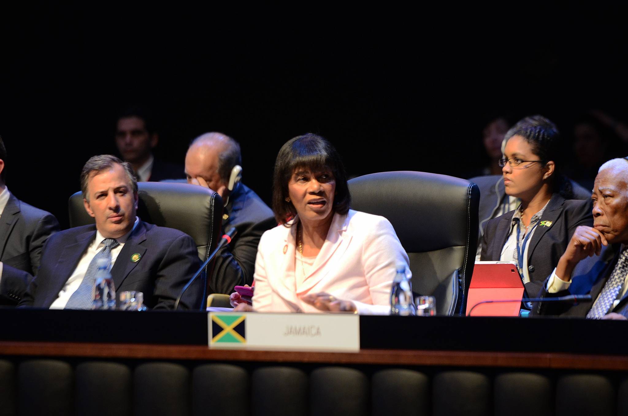 Prime Minister, the Most Hon. Portia Simpson Miller (centre), speaking at the first plenary session of the Second Summit of the Community of Latin American and Caribbean States (CELAC), in Havana, Cuba, on January  28. At right is Minister of Foreign Affairs and Foreign Trade, Senator the Hon. A. J. Nicholson.