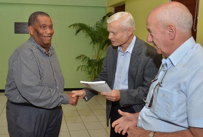 Agriculture and Fisheries Minister, Hon. Roger Clarke (left), greets Director of Research for the all-natural bio-stimulant agricultural formulation, Vitazyme, Dr. Paul Syltie (centre), during a stakeholders seminar at the Agriculture Ministry’s Research Station at Bodles, Old Harbour, St. Catherine on Tuesday (January 14). Mr. Clarke was guest speaker at the sensitization forum which was held under the theme: ‘Improving Crop production, Increasing Productivity’. Looking on is Vitazyme’s Director for Latin America and Caribbean Operations, Dr. Juan Carlos Diaz.  