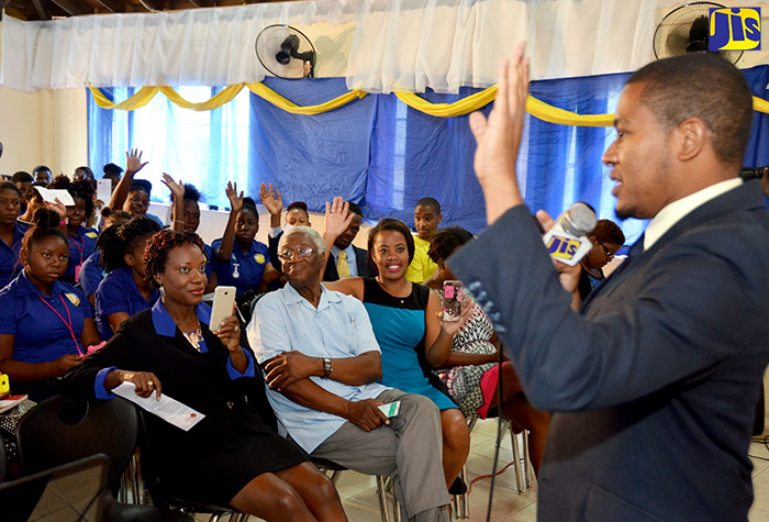 State Minister for Education, Youth and Information, Hon. Floyd Green (right), interacts with attendees at a career expo staged by the International University of the Caribbean (IUC), at its Old Hope Road location in St. Andrew on April 20.  Pictured in the front row (from left), are Chief Executive Officer of Patwa Apparel, Heneka Watkis-Porter; President of the IUC, Rev. Maitland Evans; and President, Good Deeds Foundation Jamaica, Kiddist McCoy. 