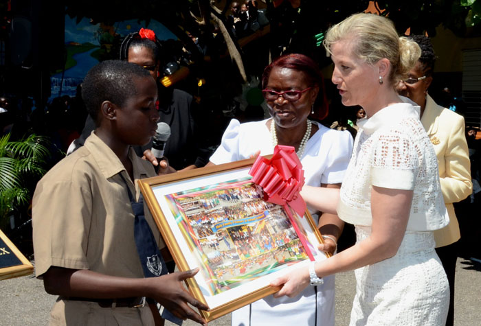 Her Royal Highness the Countess of Wessex (right); accepts a gift from student, Holy Family Primary and Infant School, Demarco Hylton (left); during a visit to the institution’s Laws Street premises in downtown Kingston on March 4. Others sharing in the moment are: Acting Principal at the school, A. Walker-Gordon (centre); and Permanent Secretary in the Ministry of Education, Elaine Foster Allen (background right). The Countess and His Royal Highness, Prince Edward, Earl of Wessex are in the island for a four-day working visit and will depart on March 5.