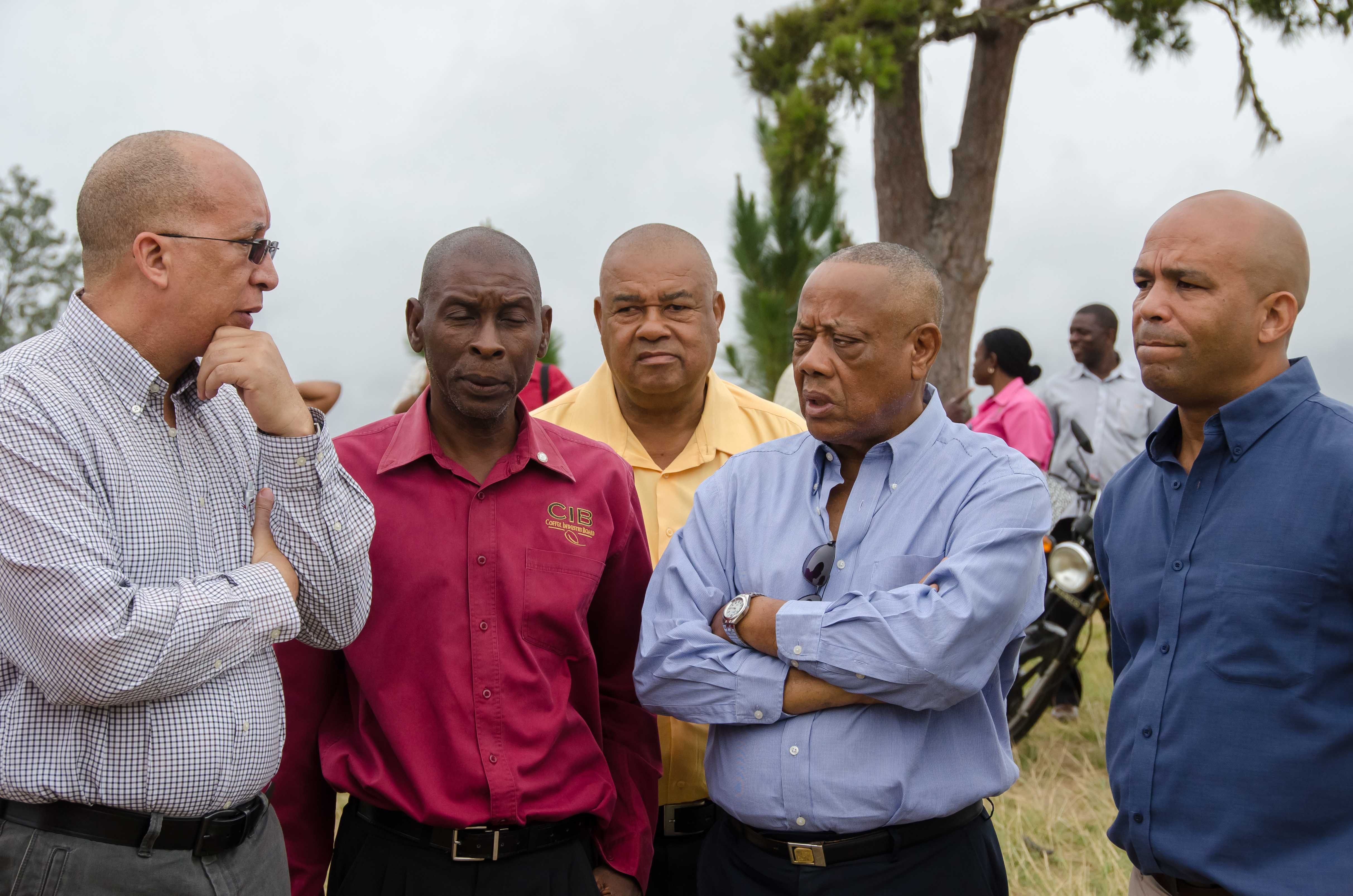 Minister of Agriculture, Labour and Social Security, Hon. Derrick Kellier (2nd left), converses with Chairman  of the Coffee Industry Board (CIB), Delano Franklyn (left), during a tour of communities in St. Thomas, which have been affected by recent bush fires. Others on the tour (from left) are: Training Coordinator at the CIB, Seiveright Dixon; Chief Executive Officer at the Rural Agricultural Development Authority (RADA), Lenworth Fulton; and Member of Parliament for Western St. Thomas, James Robertson.