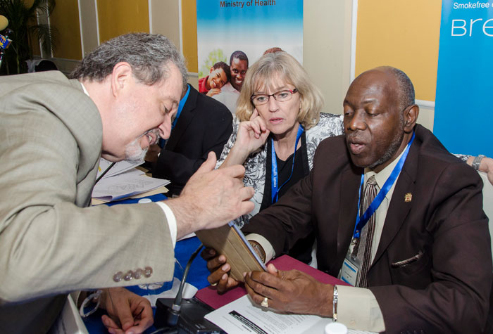 Health Minister, Hon. Dr Fenton Ferguson (right), discusses the day’s programme with Head of the Conference of Parties Convention Secretariat, World Health Organization (WHO), Dr. Tibor Szilagyi (left), and  PAHO/WHO Representative in Jamaica, Margareta Sköld, at a meeting which the Ministry hosted with the visiting team from the Secretariat of the WHO Framework Convention on Tobacco Control (FCTC), to gather information from stakeholders on the implementation of the Convention in their programmes, strategies, and plans. The forum was held at the Terra Nova Hotel in Kingston, on August 19.