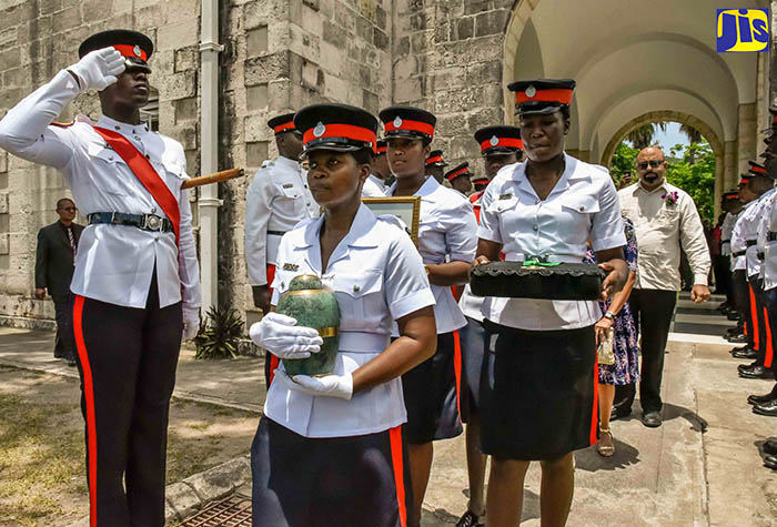Members of the Jamaica Constabulary Force (JCF) carry the urn bearing the remains of the Ambassador the Hon. Carlyle Dunkley, at the official thanksgiving service held at the University Chapel, University of the West Indies, Mona, on Wednesday (July 5). 